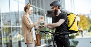 Man on bike delivering lunch to lady